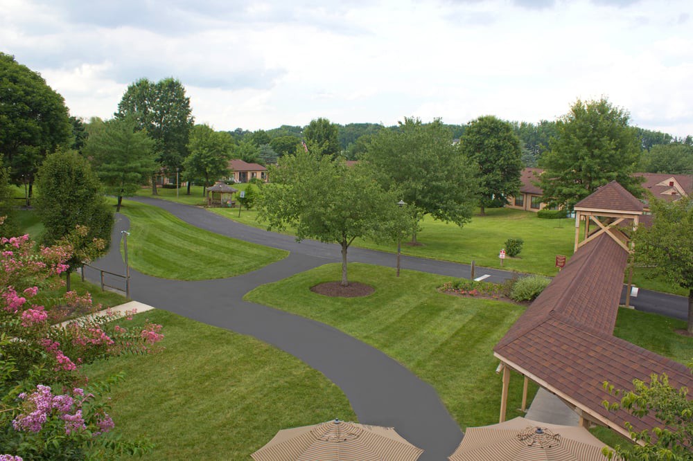 A serene suburban landscape with well-maintained lawns and winding pathways.