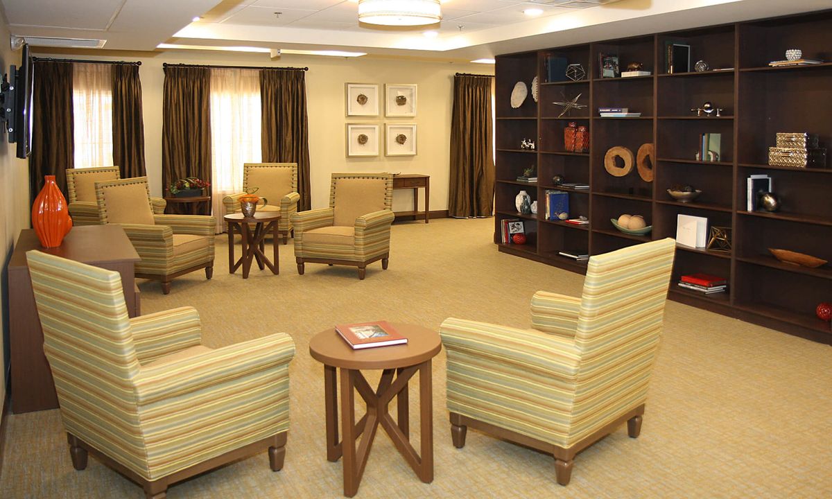 A cozy living room setup with comfortable chairs and a decorative bookshelf.
