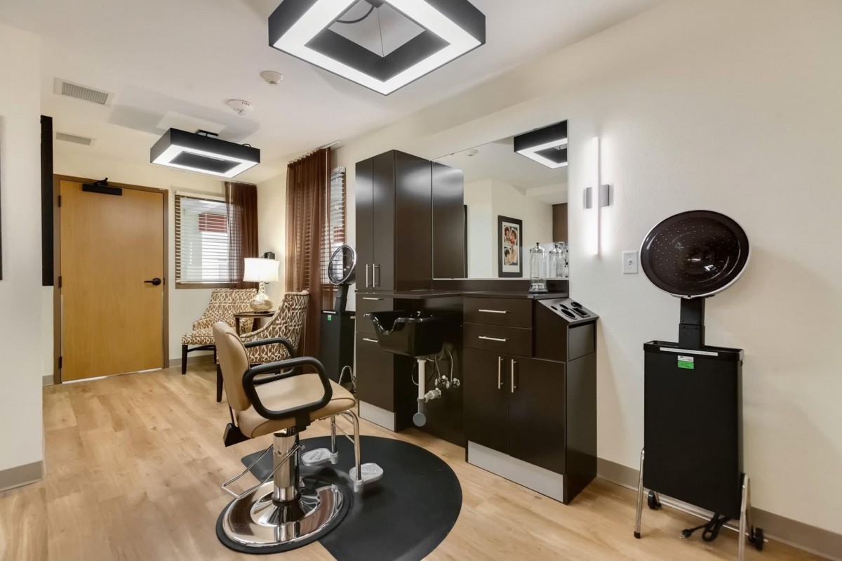 A modern hair salon interior with sleek furniture and stylish lighting.