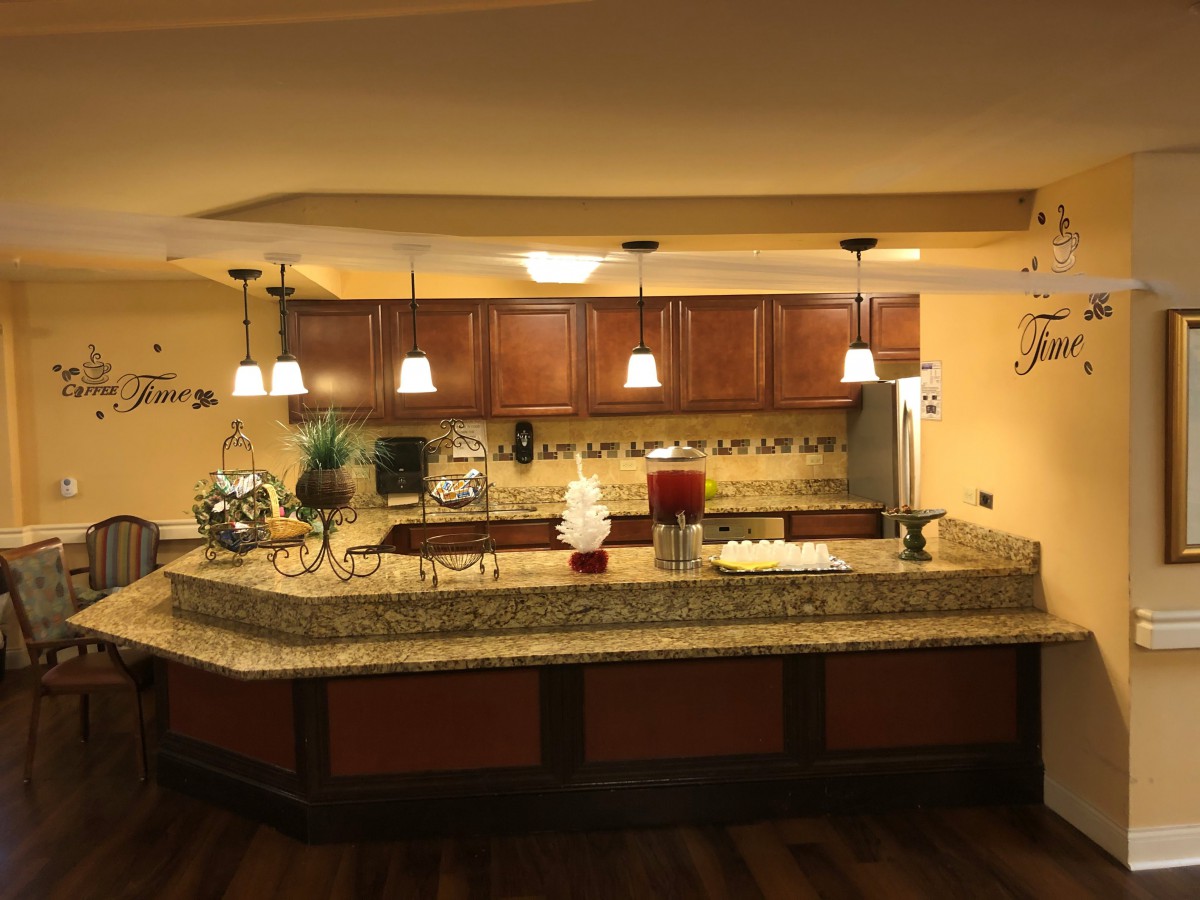 A modern kitchen with pendant lighting and a granite countertop.