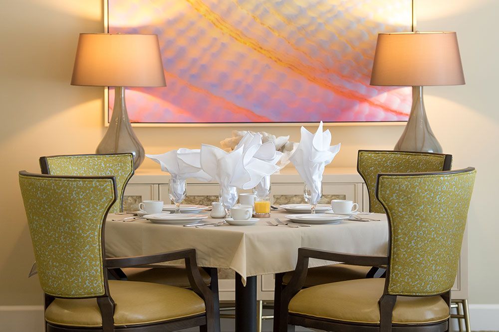 An elegantly set dining table with decorative elements and ambient lighting in a stylish restaurant.