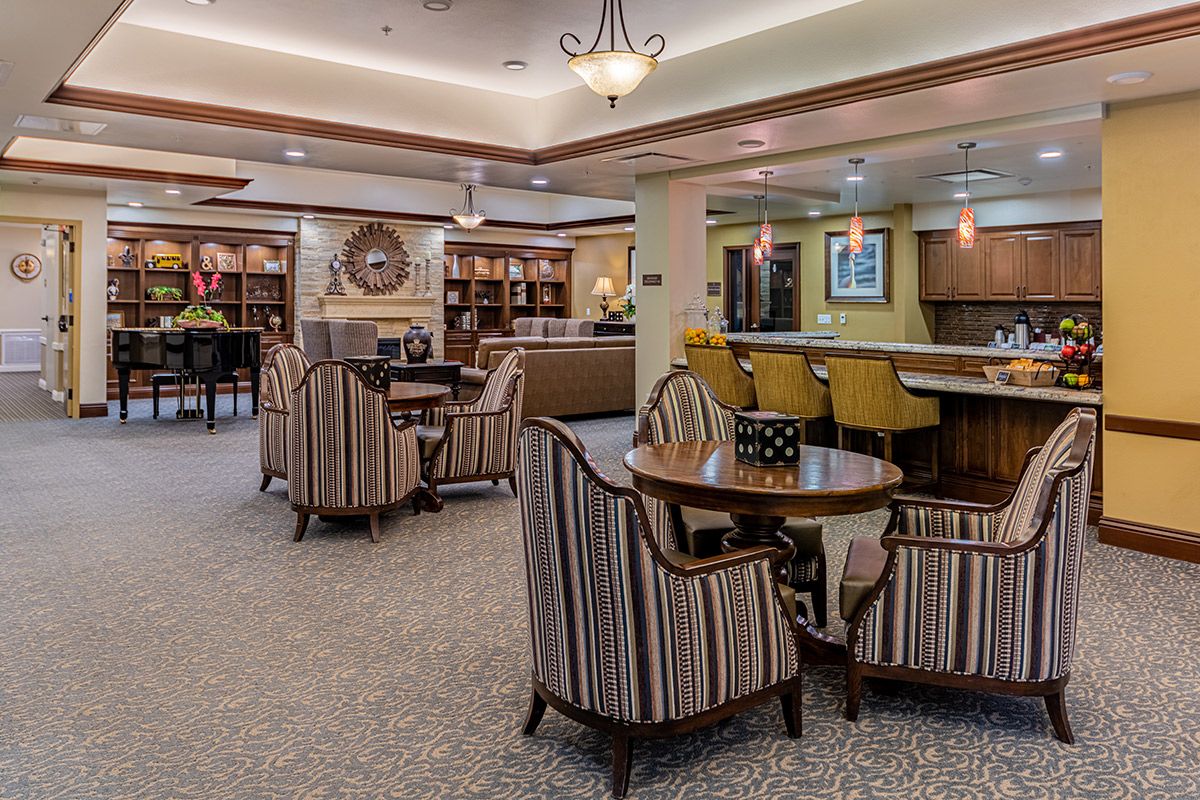 A cozy seating area with a library and decorative lighting.