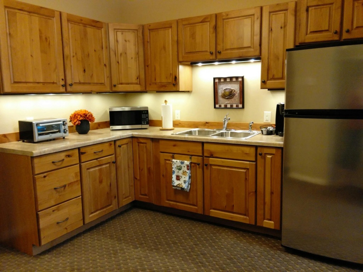 A cozy kitchen with wooden cabinetry and modern appliances.