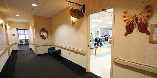 A view of a hallway with a sign, leading to an area equipped for mobility assistance.