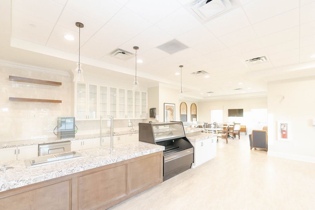 A bright and modern cafe interior with an empty counter and seating area.