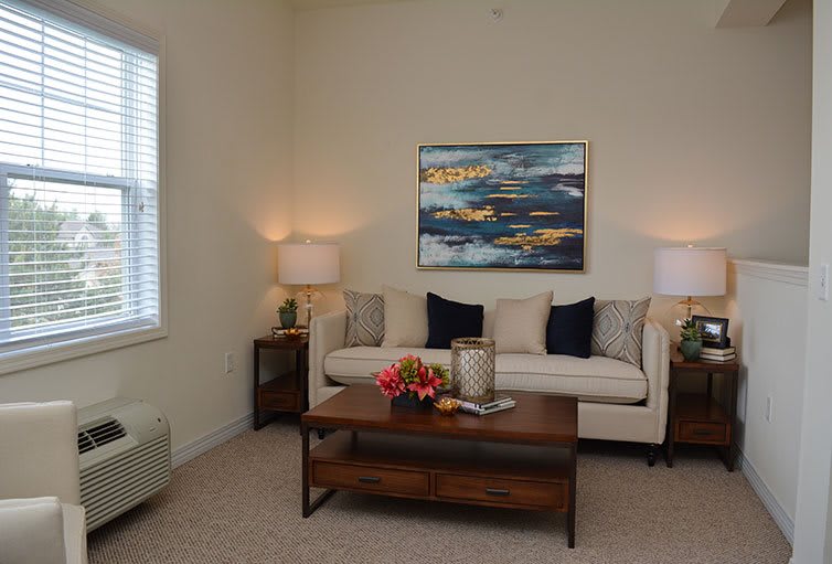 Cozy living room with a comfortable sofa, stylish artwork, and warm lighting.