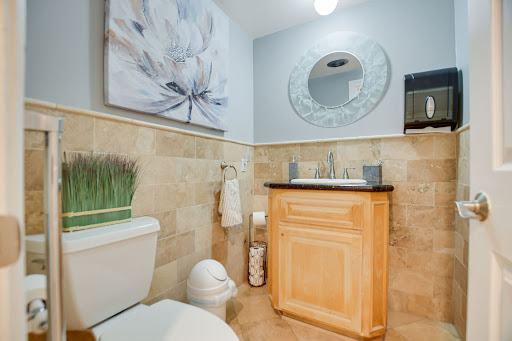 A beautifully designed bathroom featuring elegant wall art, a modern sink, and a stylish mirror.