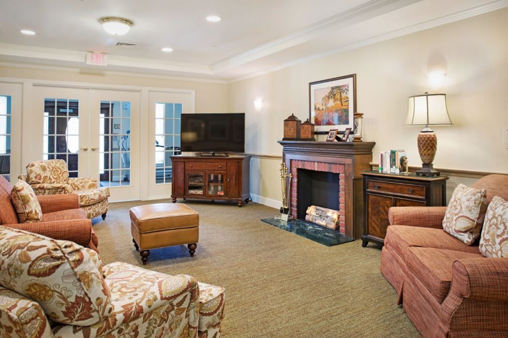 A cozy living room with a fireplace, television, and comfortable seating.