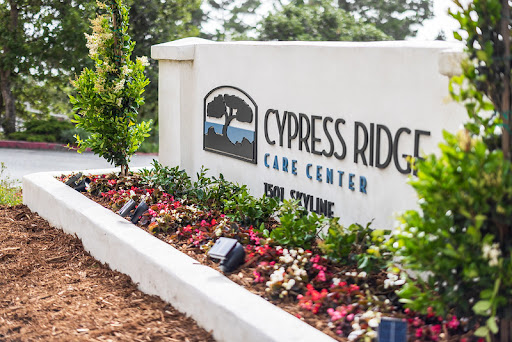 Signage of Cypress Ridge Care Center, surrounded by colorful landscaping.