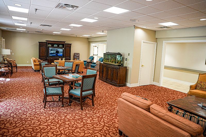 A cozy living room area with comfortable seating, a television, and an aquarium.