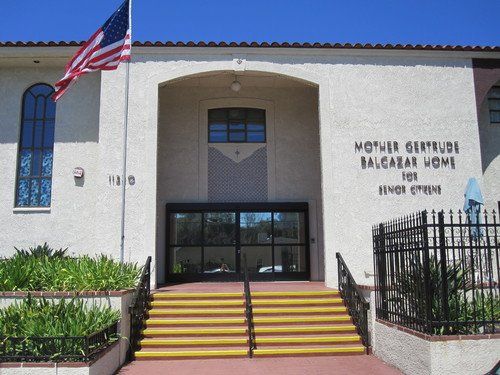 Entrance of a school building with steps and an American flag.