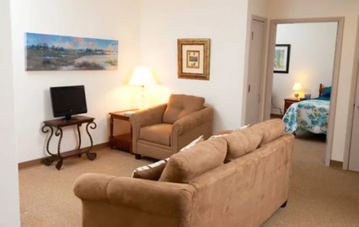 A cozy living room with comfortable seating and decorative elements.