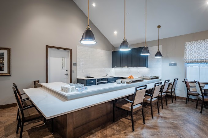 A modern kitchen with a spacious countertop and sleek pendant lighting.