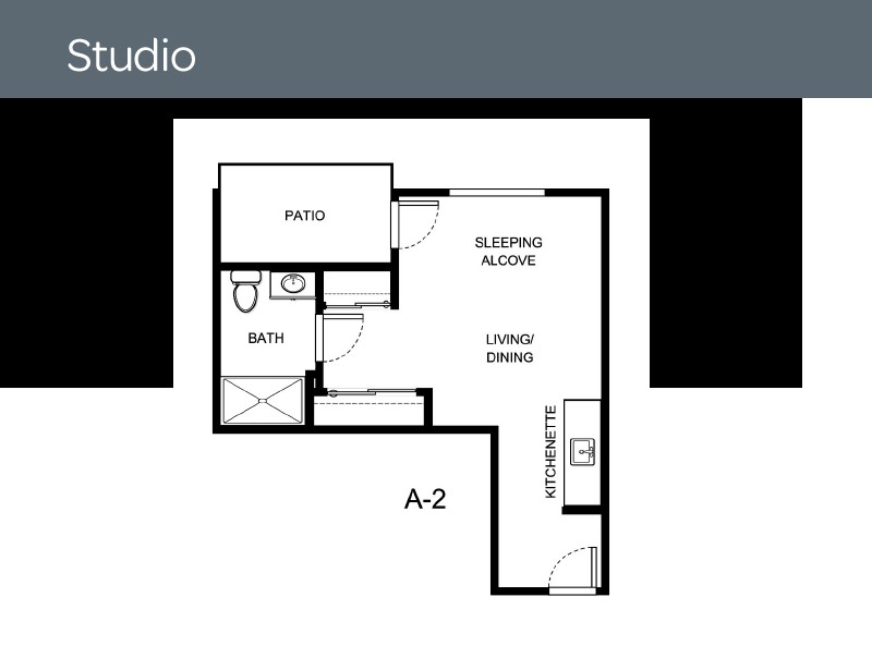 Studio apartment floor plan with bathroom, kitchen, and sleeping alcove.