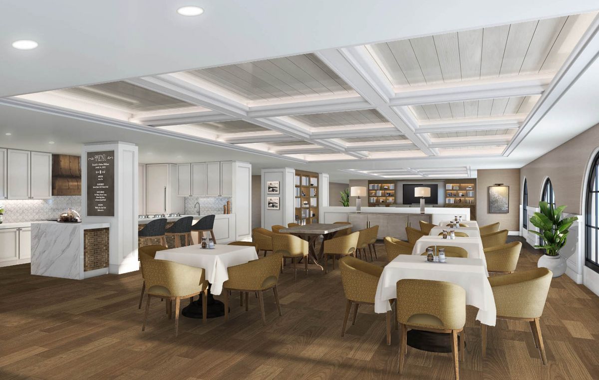 A spacious and elegantly designed dining area with neatly arranged tables and chairs.