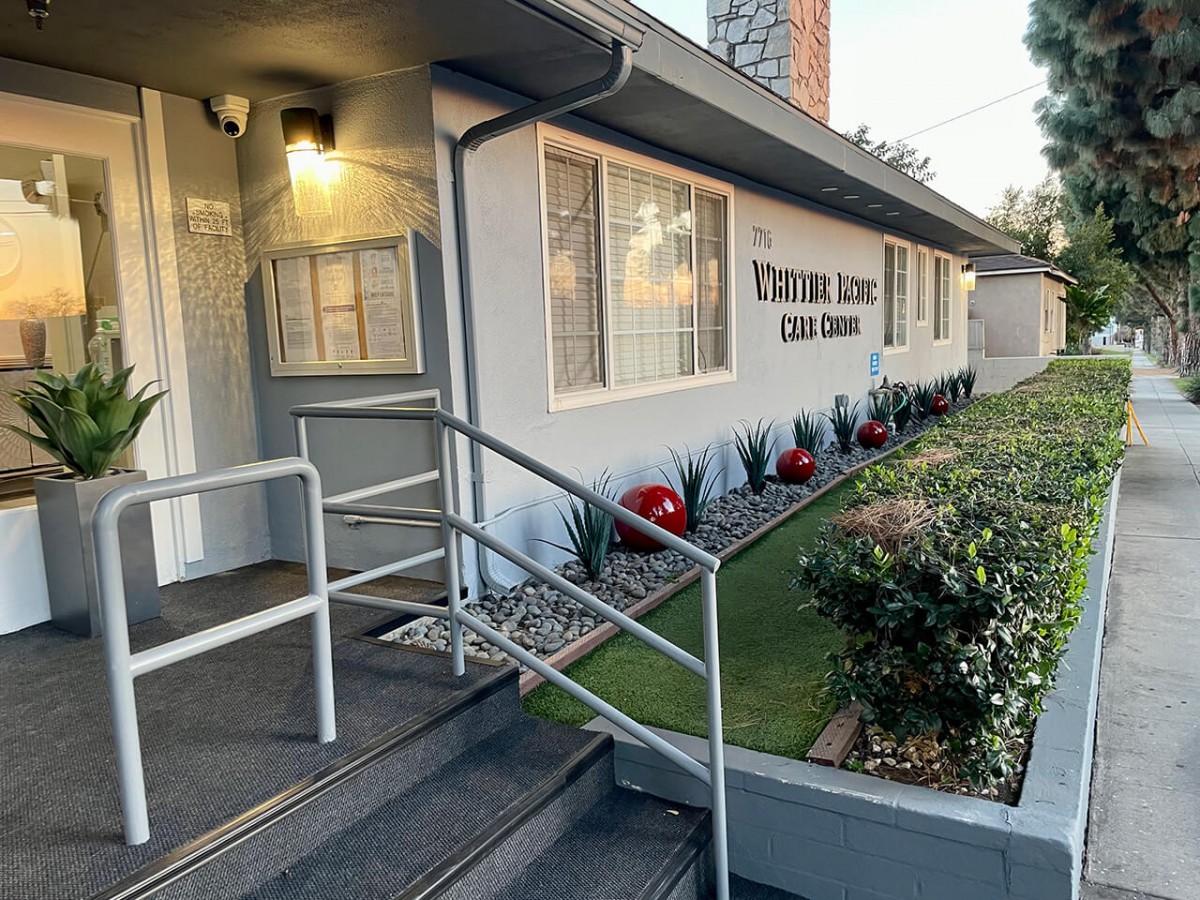 Entrance to a clinic with a ramp and well-maintained landscaping.