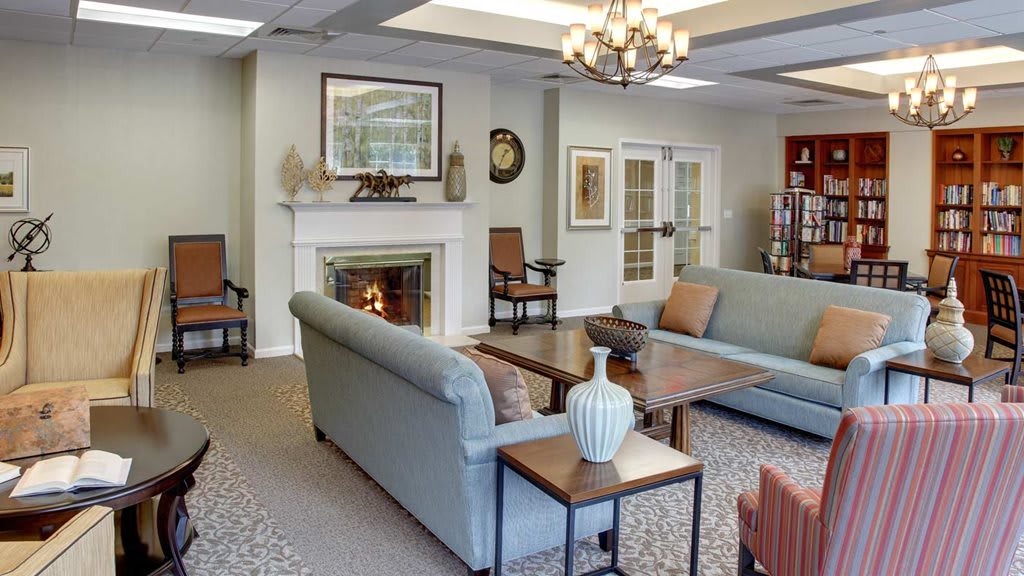 A cozy living room with stylish decor, featuring a fireplace and comfortable seating.