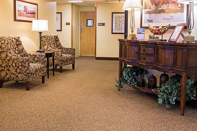 An inviting lobby area with comfortable chairs and a decorative table.