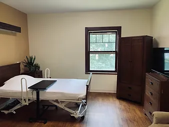 A simple room with a hospital bed and window.