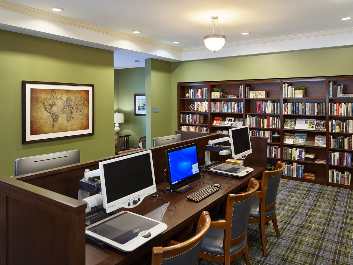 A quiet library space with computers and bookshelves for study and research.