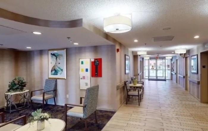 A well-lit lobby area with seating and artwork on the walls.