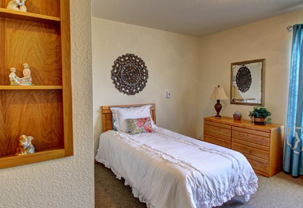 A cozy bedroom with a single bed and decorative elements.