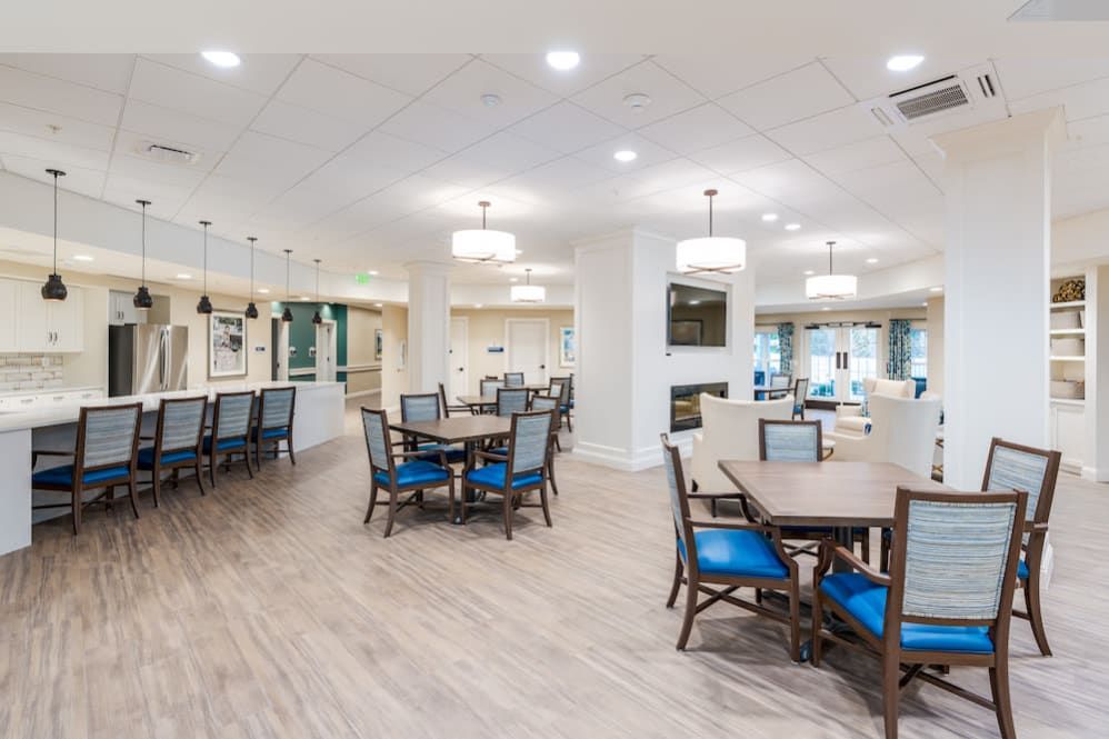 A modern and spacious dining area with elegant tables and chairs, featuring stylish lighting fixtures.