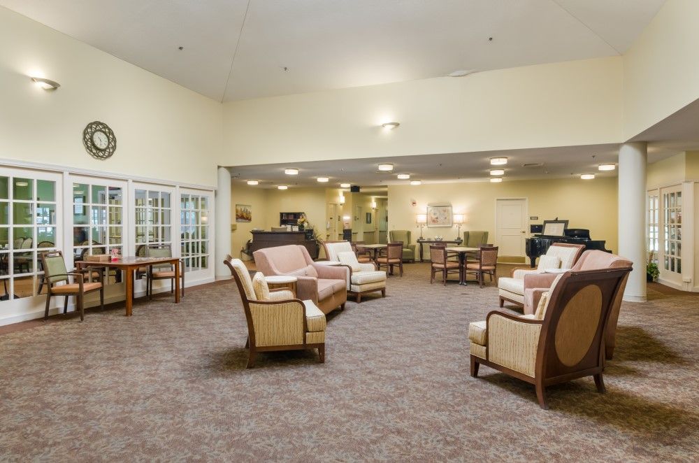 A spacious lounge area featuring comfortable seating and warm lighting.
