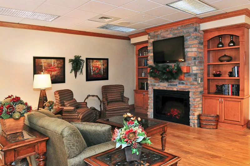 A cozy living room with a fireplace, television, and comfortable seating.