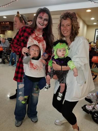 A fun Halloween gathering featuring creative costumes for both adults and kids.