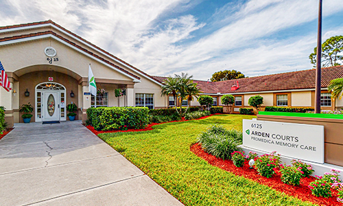A healthcare facility with well-maintained landscaping and clear signage on a sunny day.