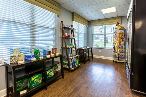 A neatly organized interior of a small store showcasing various products on shelves.