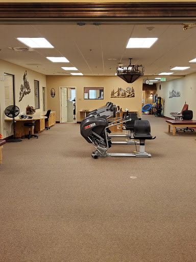 A spacious fitness studio equipped with various exercise machines and a welcoming atmosphere.