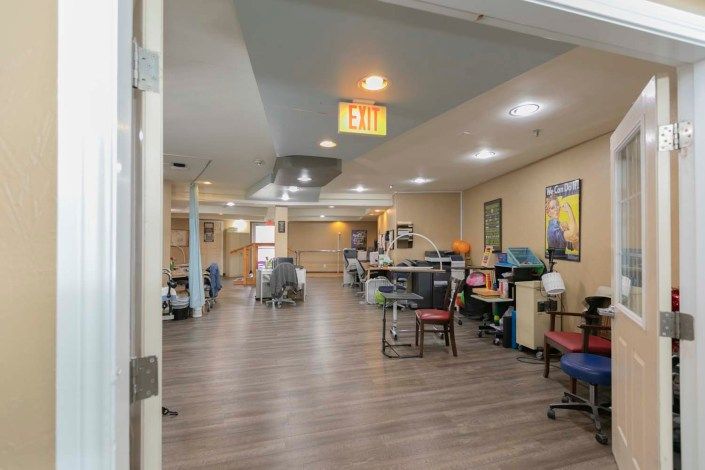 A spacious office hallway with workstations and modern interior design.