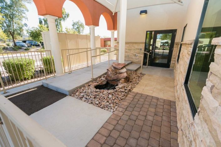 An entrance with a ramp and doorway, featuring modern architectural design.