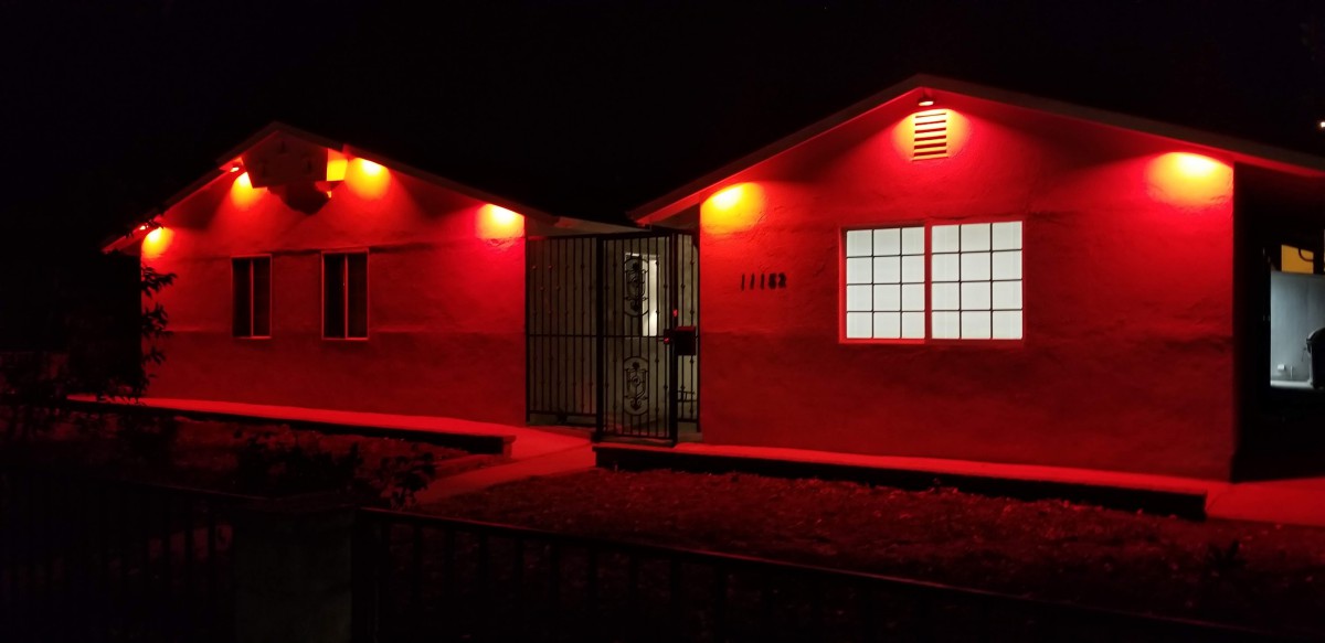 A building illuminated by red lights at night.