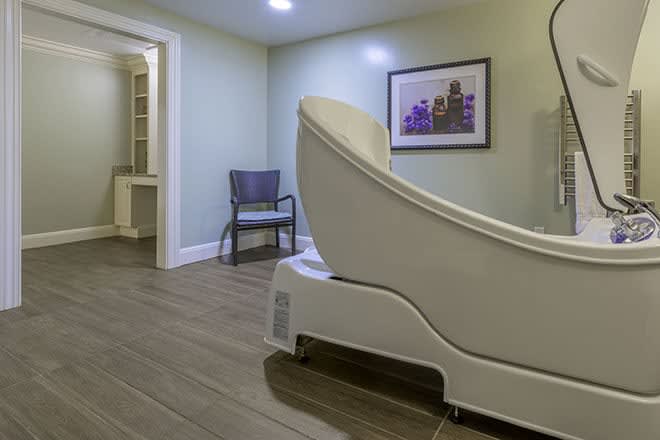 A serene spa room featuring a modern massage chair and soothing decor.