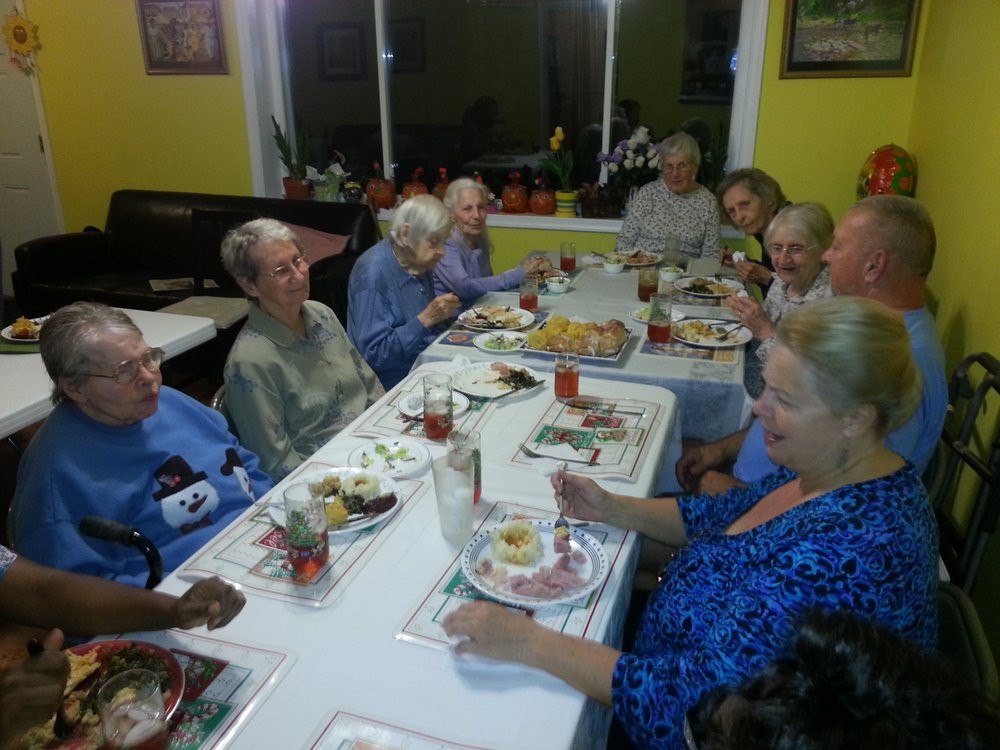 A group of people enjoying a meal together at a dinner table.