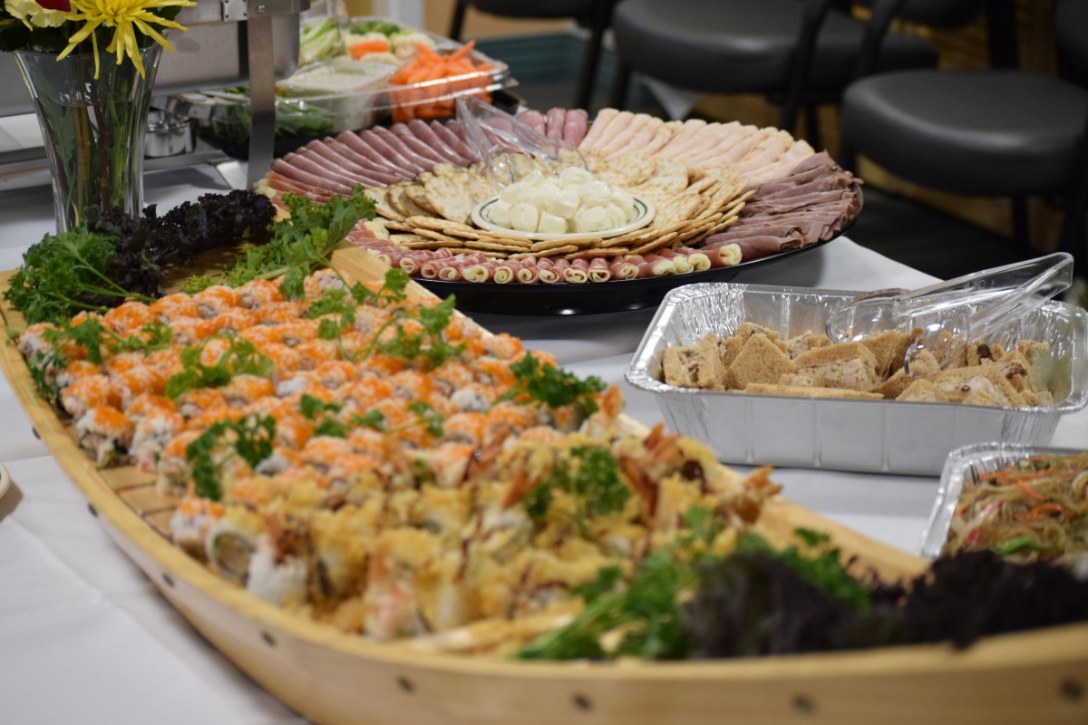 A lavish buffet setup featuring assorted sushi and seafood platters.