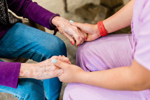 A moment of connection and support between two people, highlighting the power of touch and care.