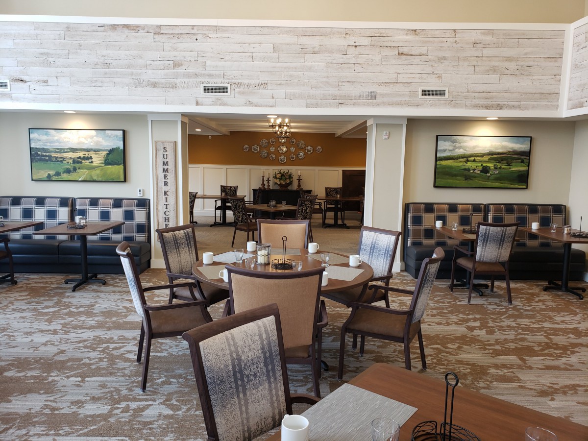 A cozy dining area with neatly arranged tables and chairs in a restaurant setting.