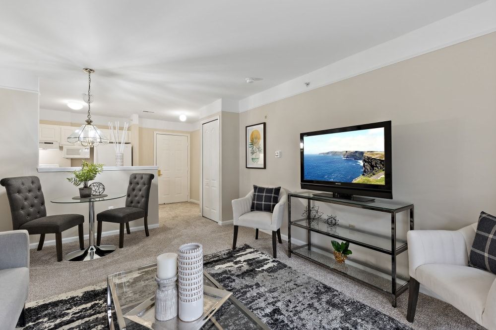 A modern open-concept living room with a dining area featuring stylish furniture and decor.