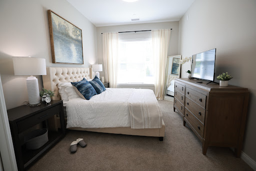 A serene and modern bedroom featuring a comfortable bed, elegant decor, and abundant natural light.