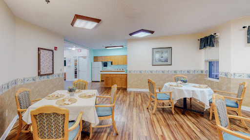 A cozy dining area featuring elegantly set tables in a residential facility.