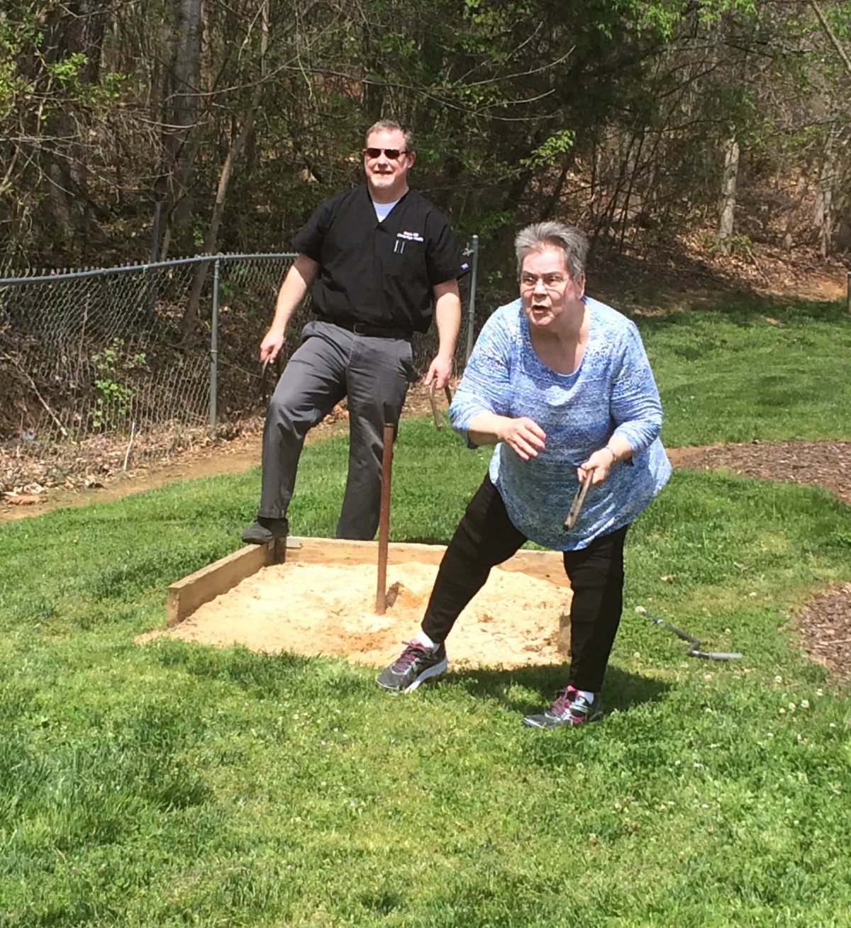 Two people enjoying an outdoor activity on a sunny day.