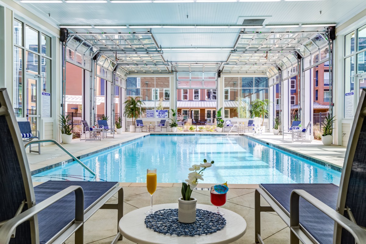 A luxurious indoor pool area with seating and refreshments, inviting relaxation and leisure.