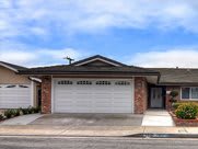 A suburban house with a double garage and driveway.