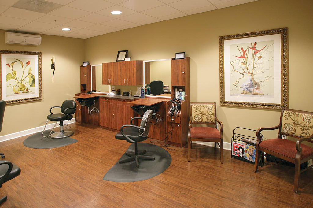 A cozy hair salon with styling stations and a waiting area.