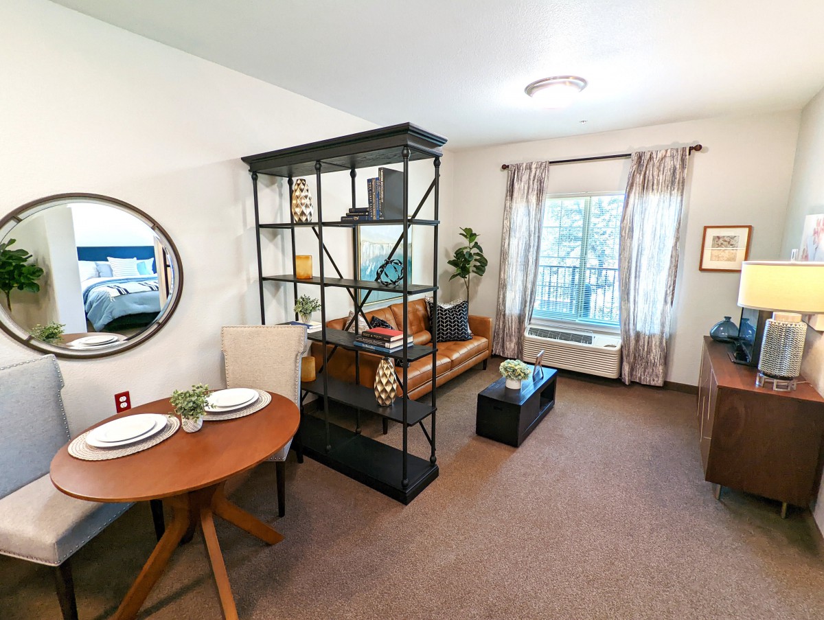 A modern living room with a stylish shelving unit and cozy decor.