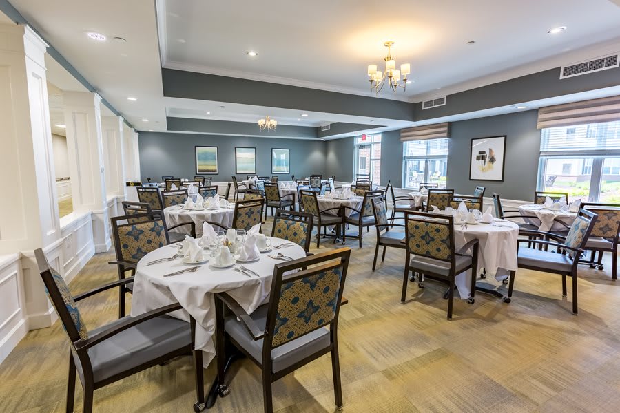 An elegant dining room with neatly arranged tables and chairs.